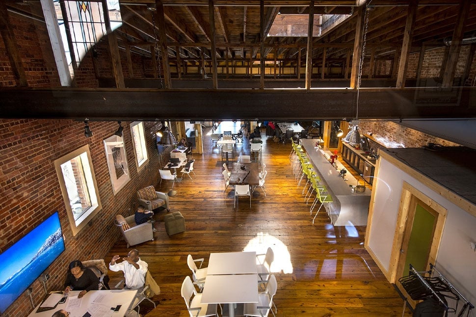 Modern co-working space with rustic brick walls and stylish furniture for entrepreneurs.