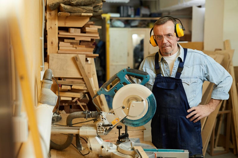 A woodworker in his North Carolina workshop using the entrepreneurship skills needed to run a custom furniture business.